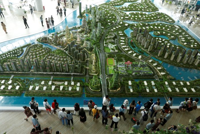 Prospects look at a model of the development at the Country Gardens' Forest City showroom in Johor Bahru