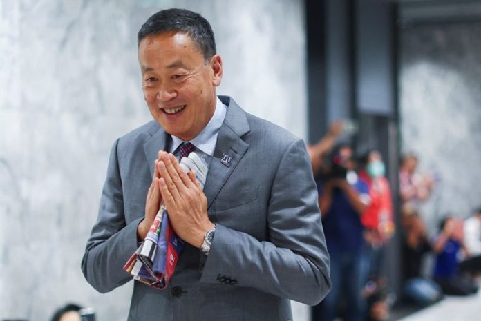 Pheu Thai's Srettha Thavisin gestures at the party headquarters in Bangkok