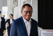 நஜிப் ஆதரவு பேரணி: அம்னோ, பாஸ் தலைவர்கள் மோதல்