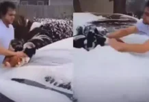 3 மாத குழந்தையை பயன்படுத்தி காரில் பனியை துடைத்த வாலிபர்